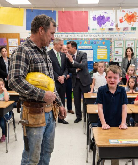 My old, grease-stained toolbelt made me the joke of Career Day — but one boy’s trembling confession turned the laughter into heavy silence.